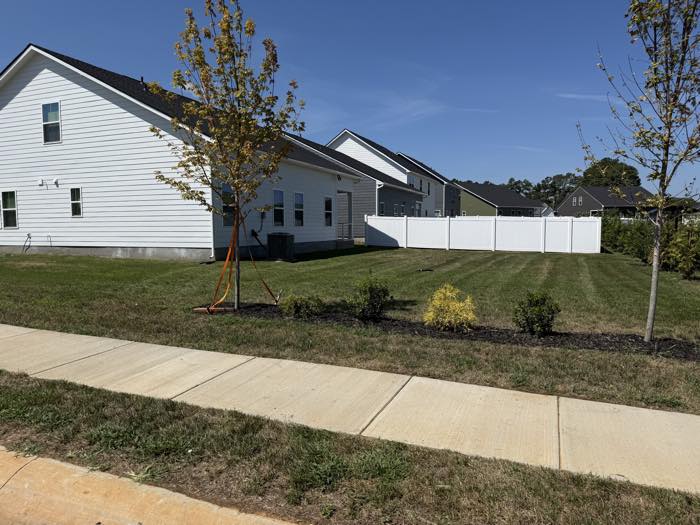 New-build home with fresh landscaping and a cut lawn